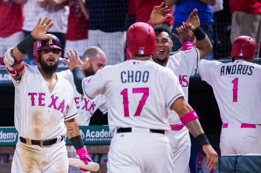 Texas Rangers designated hitter Shin-Soo Choo (17) and shortstop Elvis Andrus (1) celebrate...