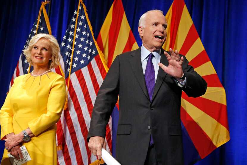 FILE - In this Nov. 8, 2016, file photo, Sen. John McCain, R-Ariz., right, waves to...