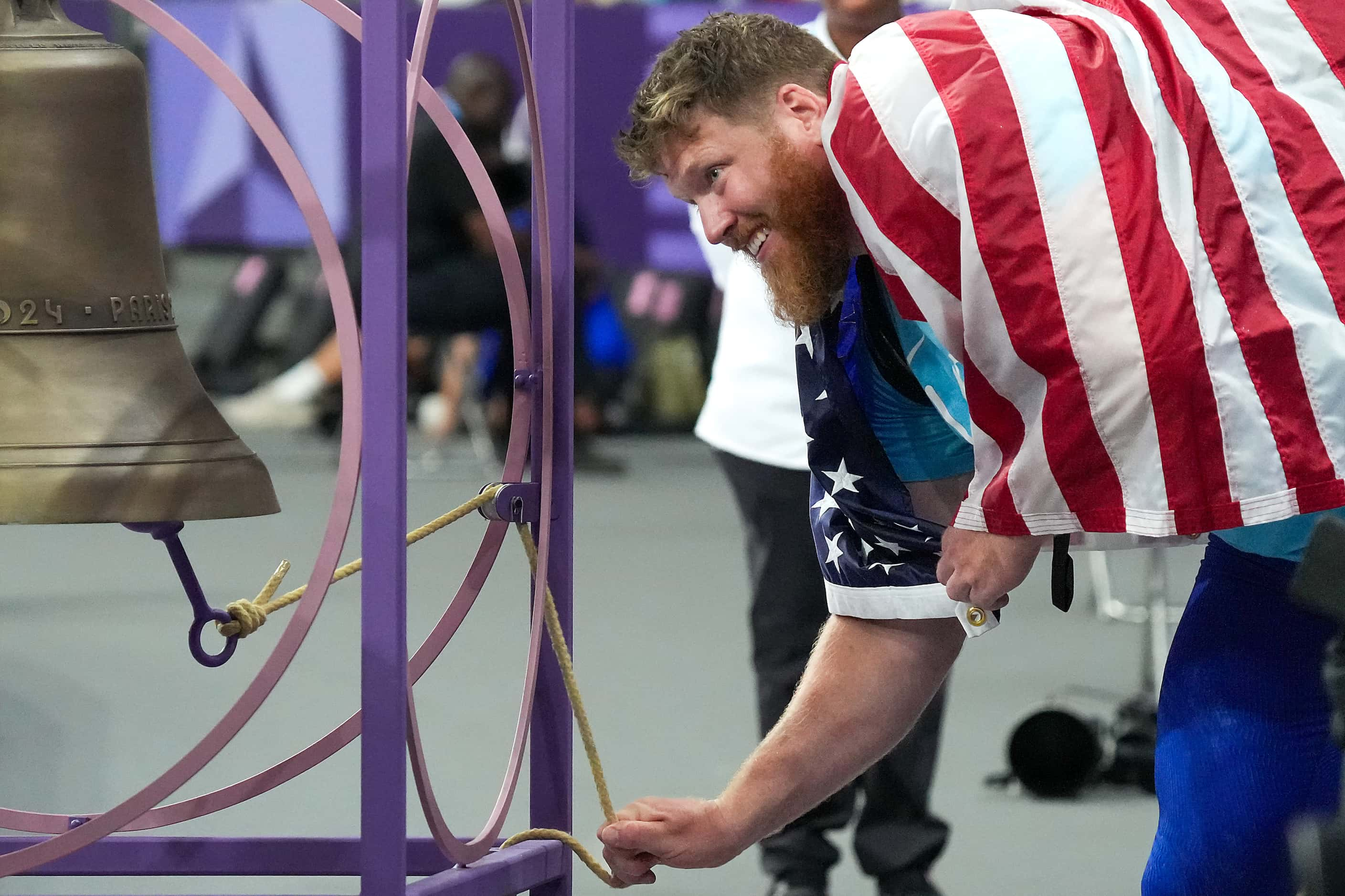 Ryan Crouser of the United States rings a bell after winning the gold medal in the men’s...