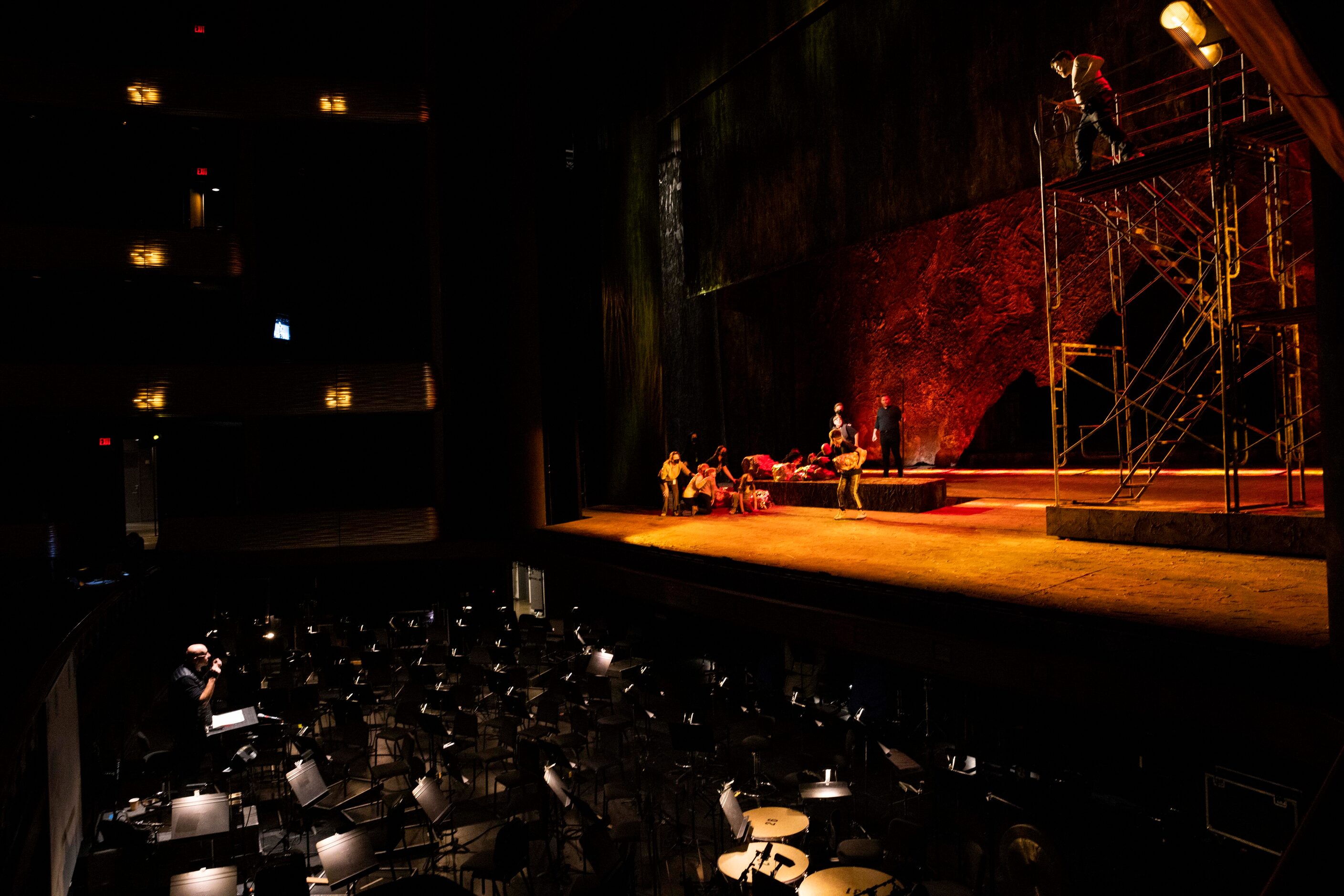 Baritone Michael Mayes (left) performs during staging rehearsal on a scaffolding made by...