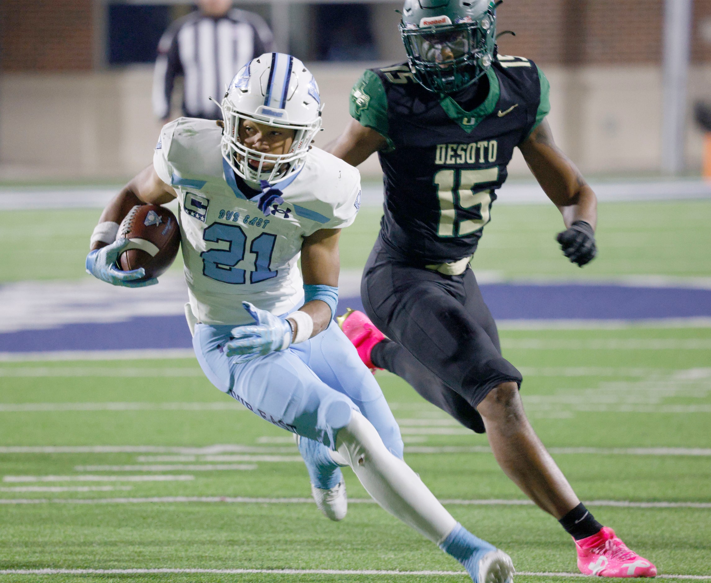 Wylie East's Michael Henderson III (21) keeps the ball away from DeSoto's Keylan Abrams (15)...