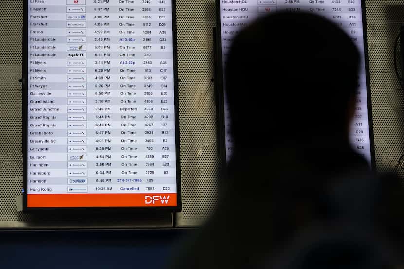 A cancelled flight departing to Hong Kong is shown on the board in Terminal D at DFW...