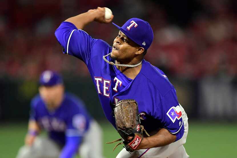 Texas Rangers starting pitcher Edinson Volquez throws during the first inning of the team's...