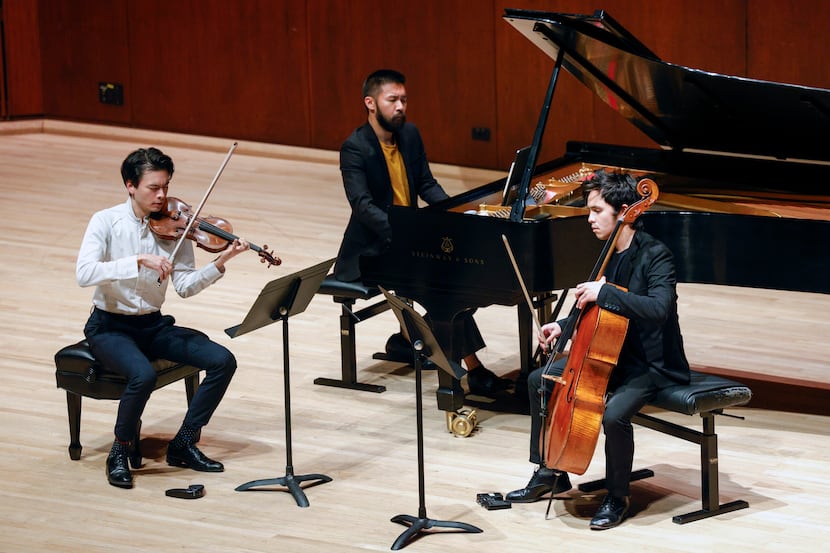 Violinist Stefan Jackiw (left), pianist Conrad Tao (center) and cellist Jay Campbell perform...