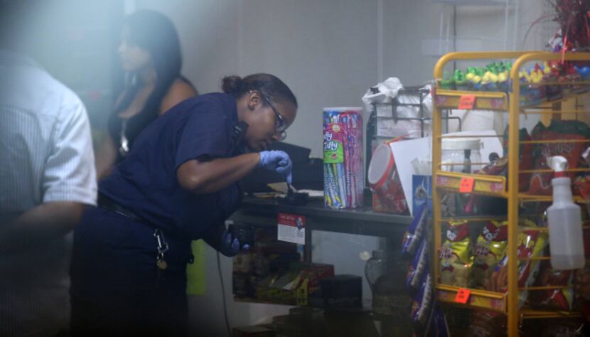 Crime scene analyst Carmella Nuttroy took fingerprints after Cristobal DeLeon’s store was...