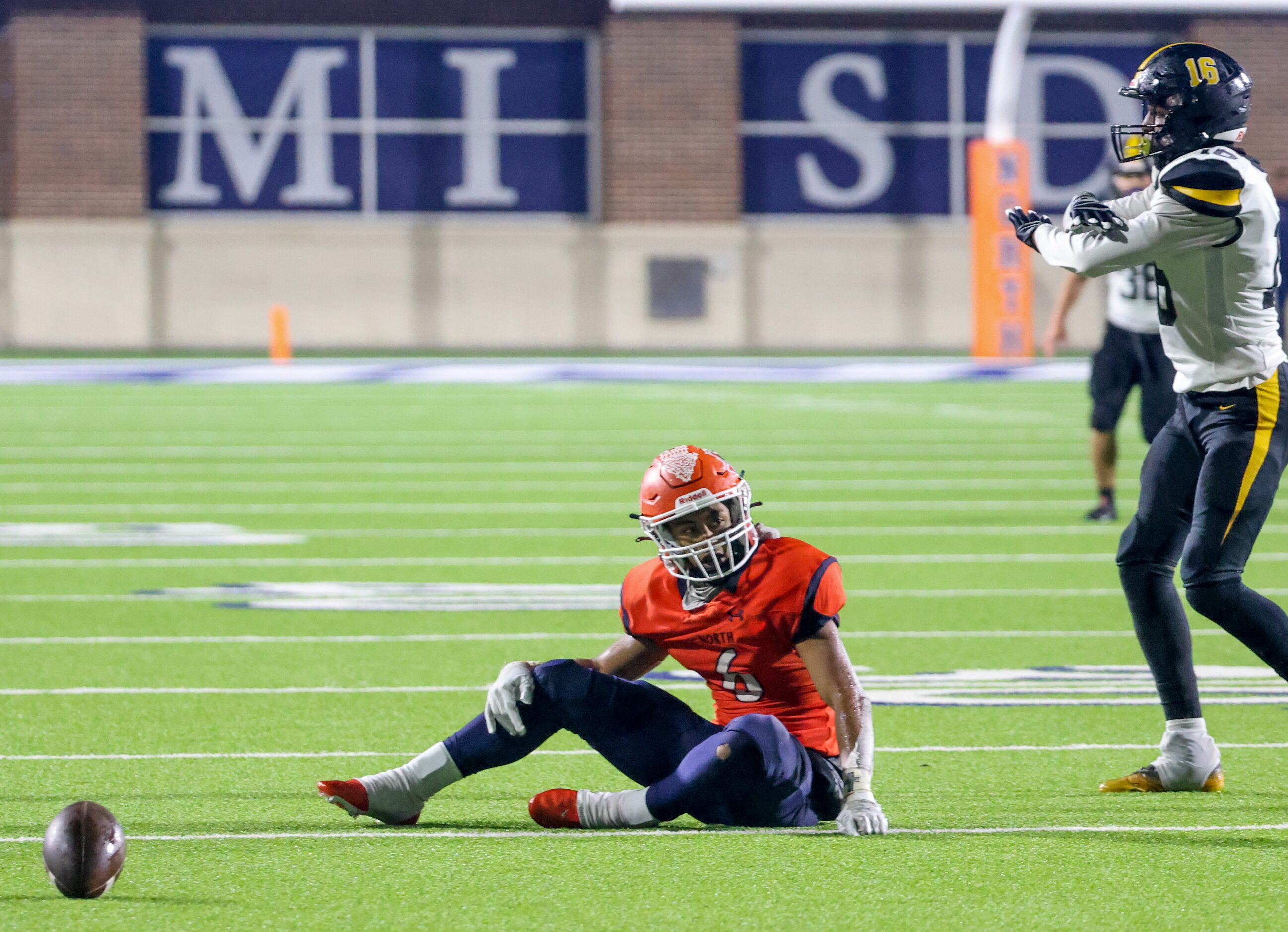 McKinney North quarterback Gavin Constantine (6) sits on the ground after being tackled by...