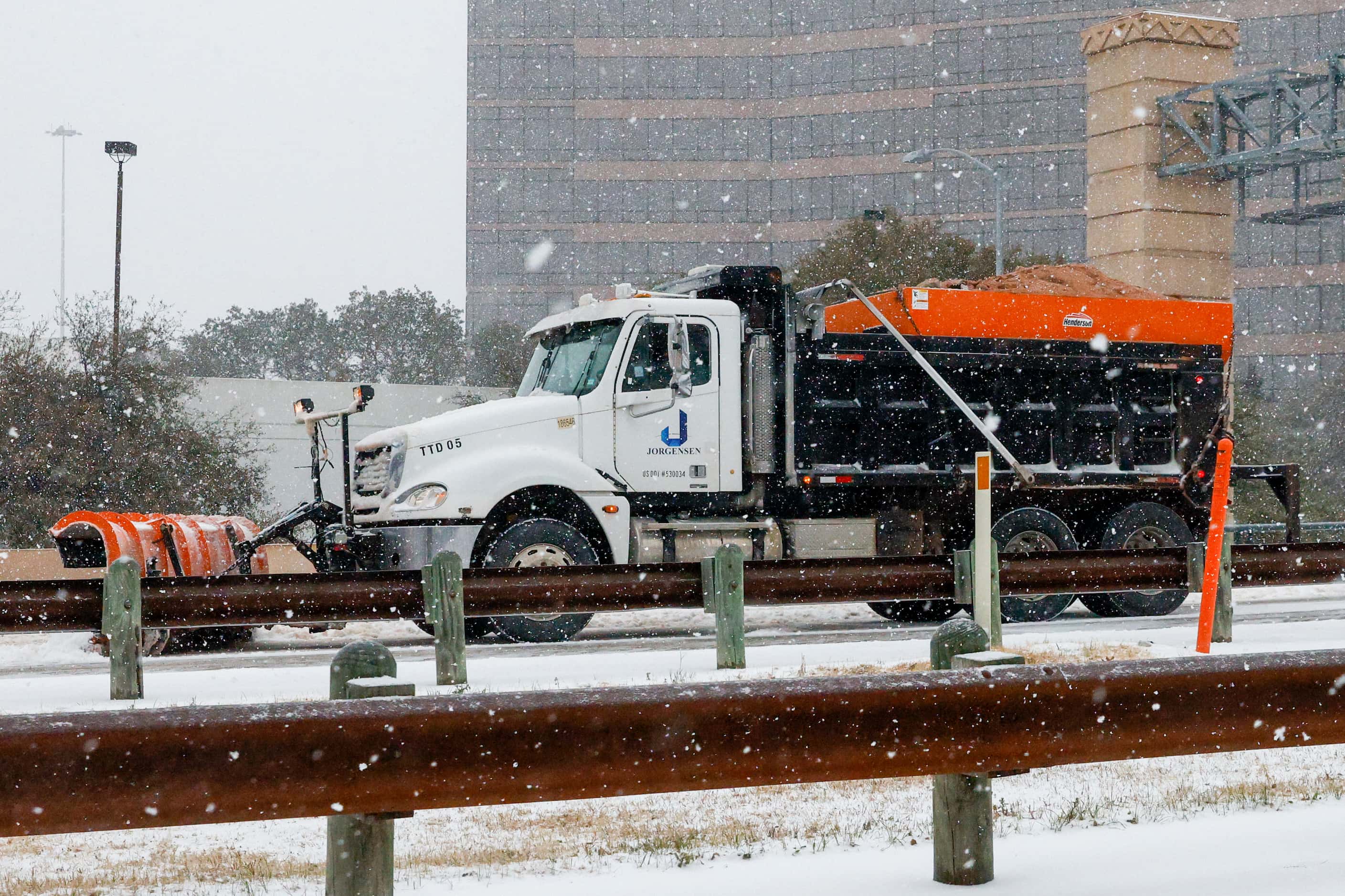 A snowplow and sanding truck clears the road along Chisholm Trail Parkway near downtown on...
