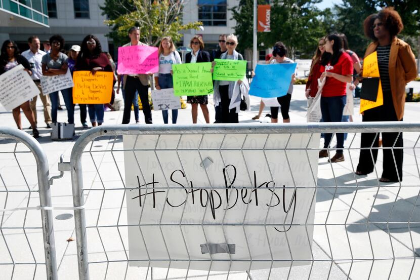 Victims of sexual violence and their supporters gather to protest before a speech by...