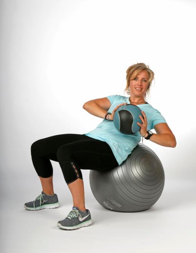 
Spoonts, a personal trainer from Addison, demonstrates the 8-pound med-ball crunch, adding...