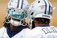 Dallas Cowboys wide receiver CeeDee Lamb (88) talks with running back Ezekiel Elliott (21),...