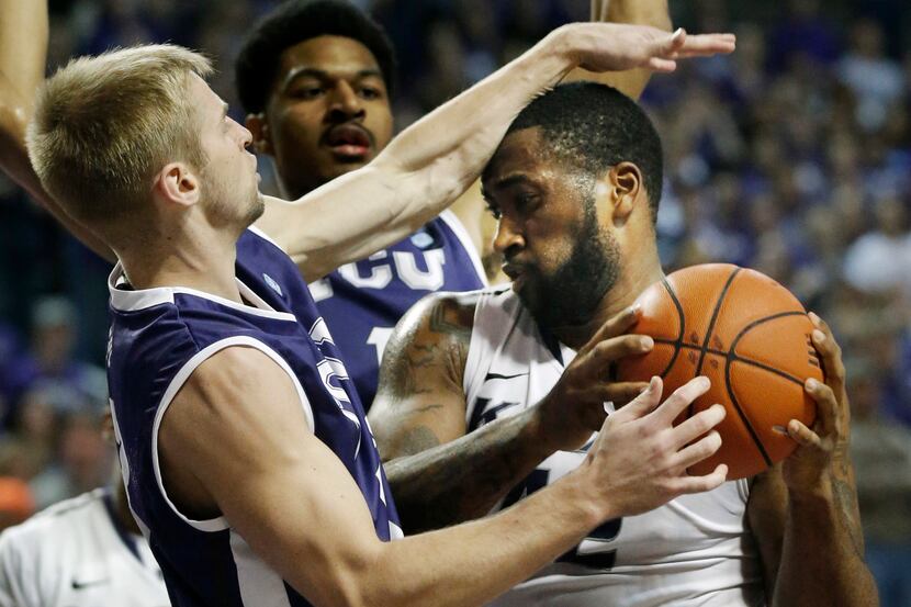 Kansas State forward Thomas Gipson, right, is fouled by TCU guard Christian Gore, left,...