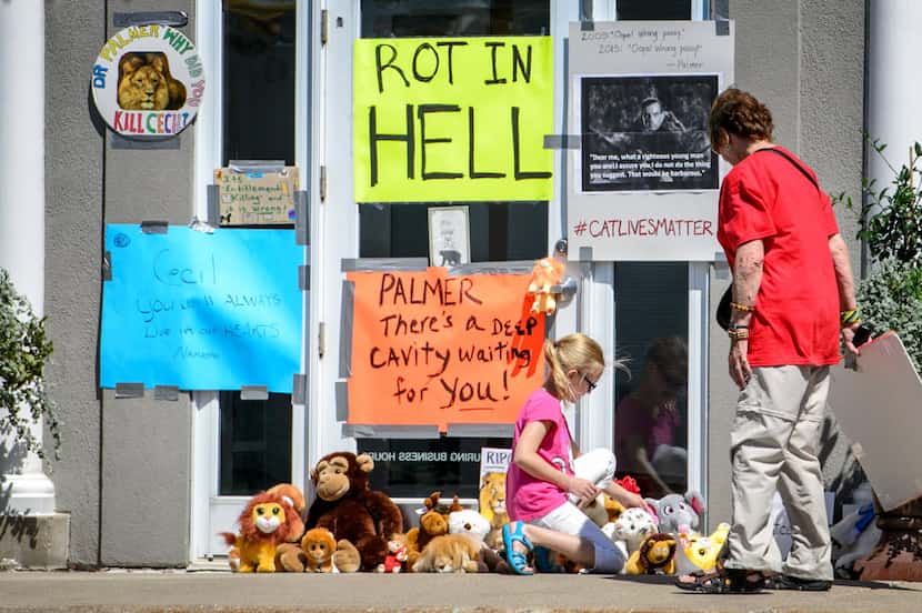 Protesteors left signs and stuffed animals in front of Dr. Walter Palmer's Bloomington,...