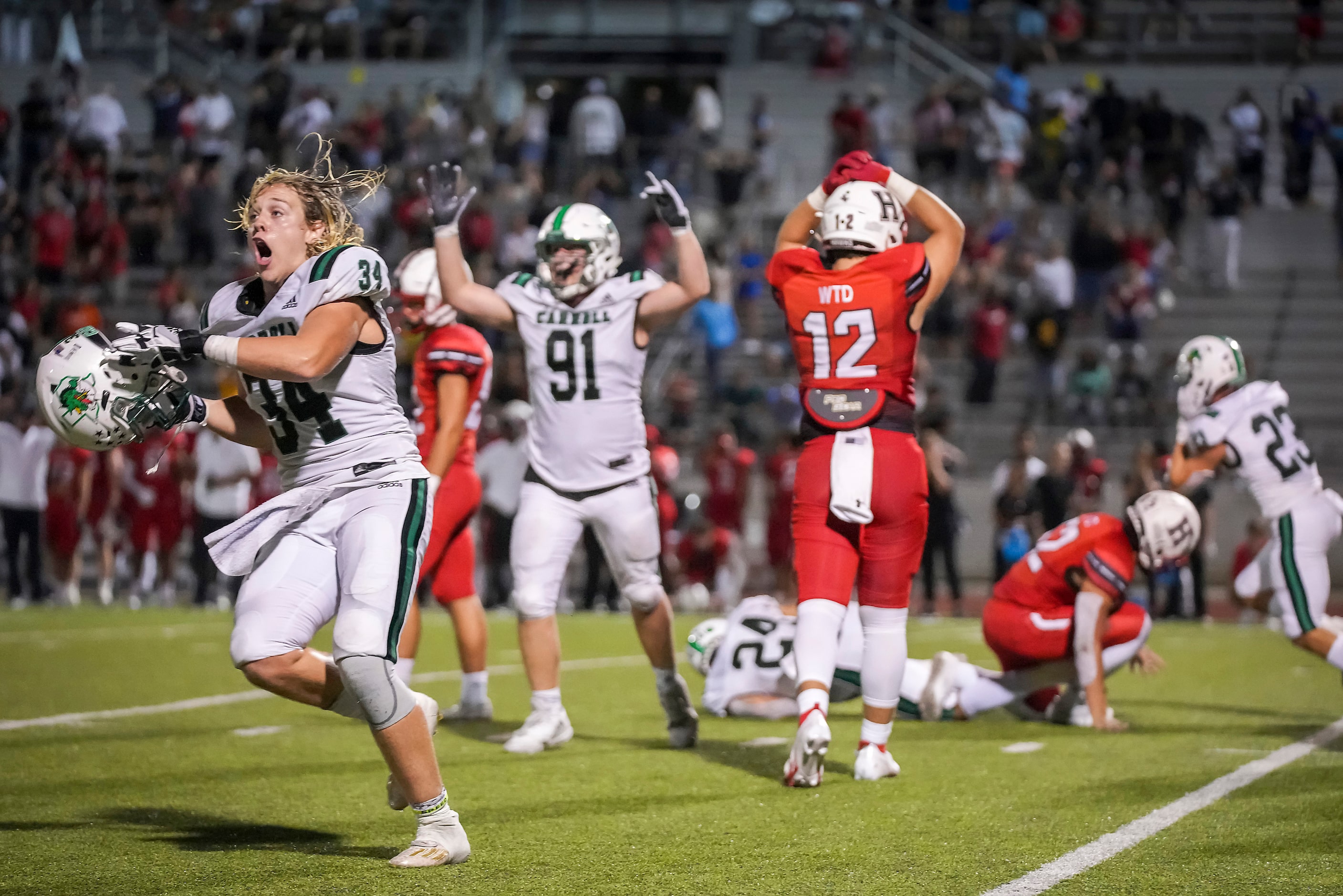 Southlake Carroll defensive linemen Travis Keener (34) and Calder Bray (91) celebrate after...