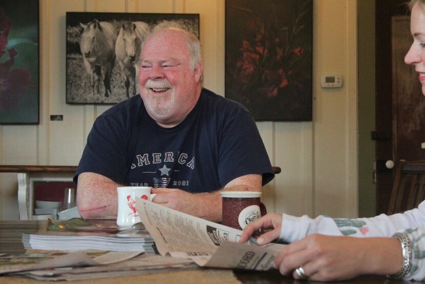 Johnnie McNellie, owner of Espressions coffee shop in Round Top, has coffee with other local...