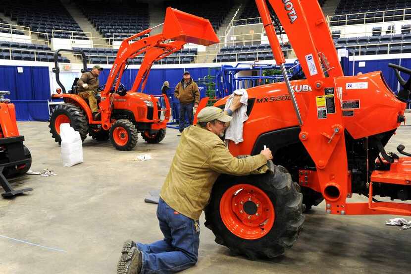 Ronnie Penick wipes down a Kubota tractor in preparation for the Texas Farm, Ranch and...