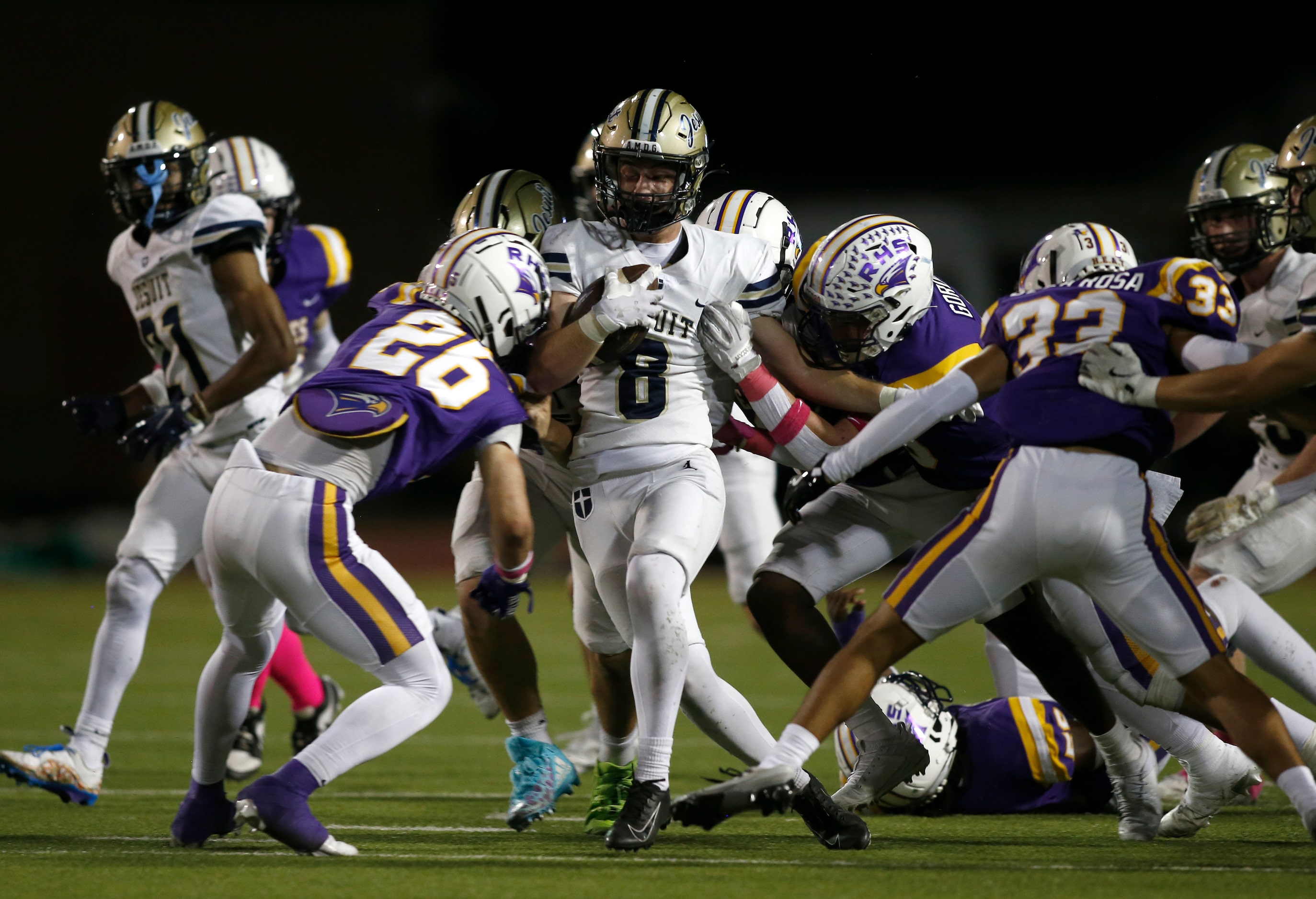 JesuitÕs Merritt Johnson (8) carries the ball as he is hit by Richardson defensive back...