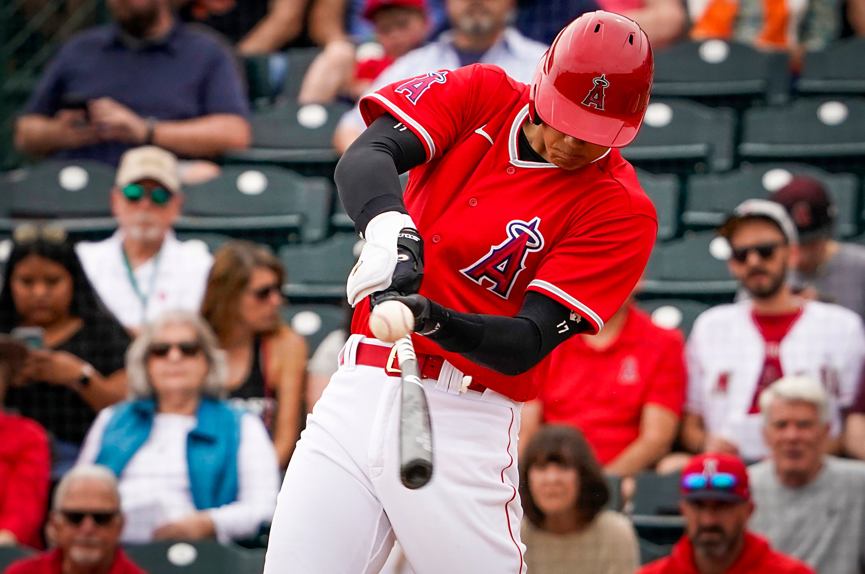 Los Angeles Angels designated hitter Shohei Ohtani drives in a run with a single during the...