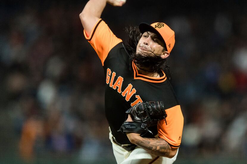 San Francisco Giants starting pitcher Dereck Rodriguez throws against the Texas Rangers in...