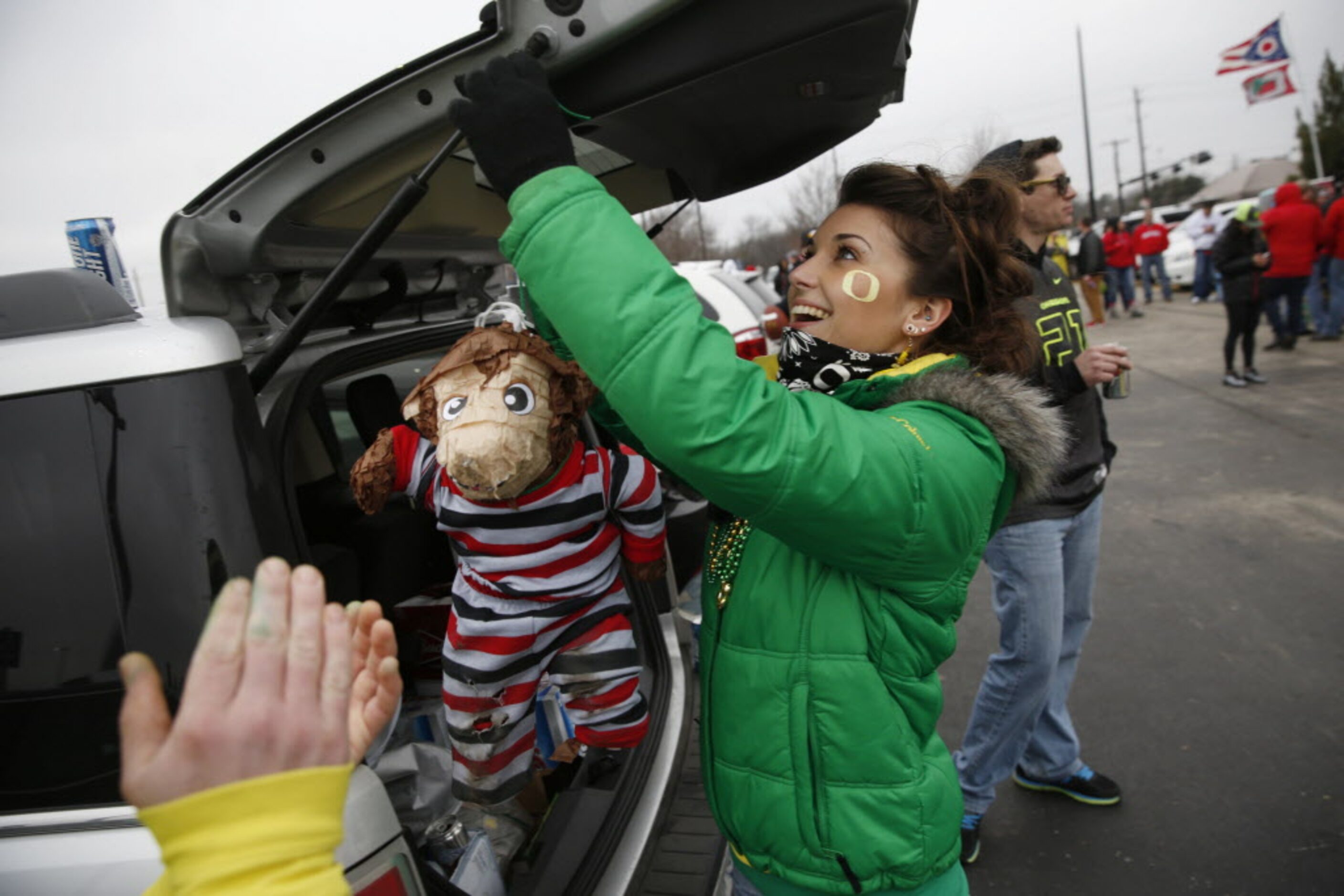 Oregon Ducks fan Jessica Tutt, Eugene, Oregon, hangs a Ohio State Buckeyes effigy before the...