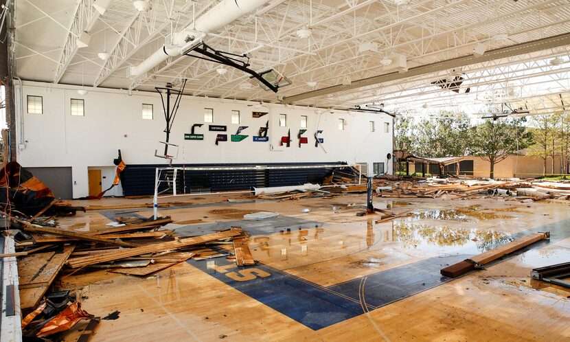 The gymnasium walls at St. Mark's School of Texas were blown over during the tornado in...