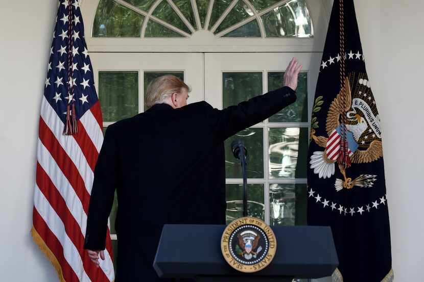 President Donald Trump waves after making a statement announcing that a deal has been...