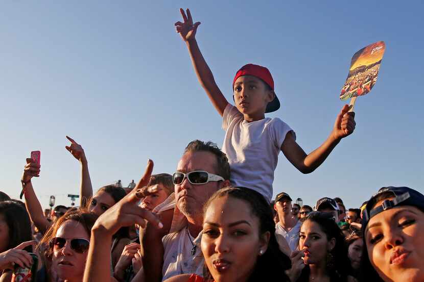 Fans of rapper J. Cole sing along with his music during the Suburbia Music Fest at Oak Point...
