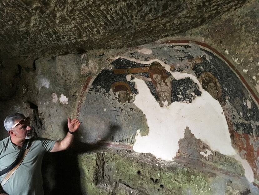Tonio Creanza, founder and director of Messors, gestures near a fresco in the crypt of...