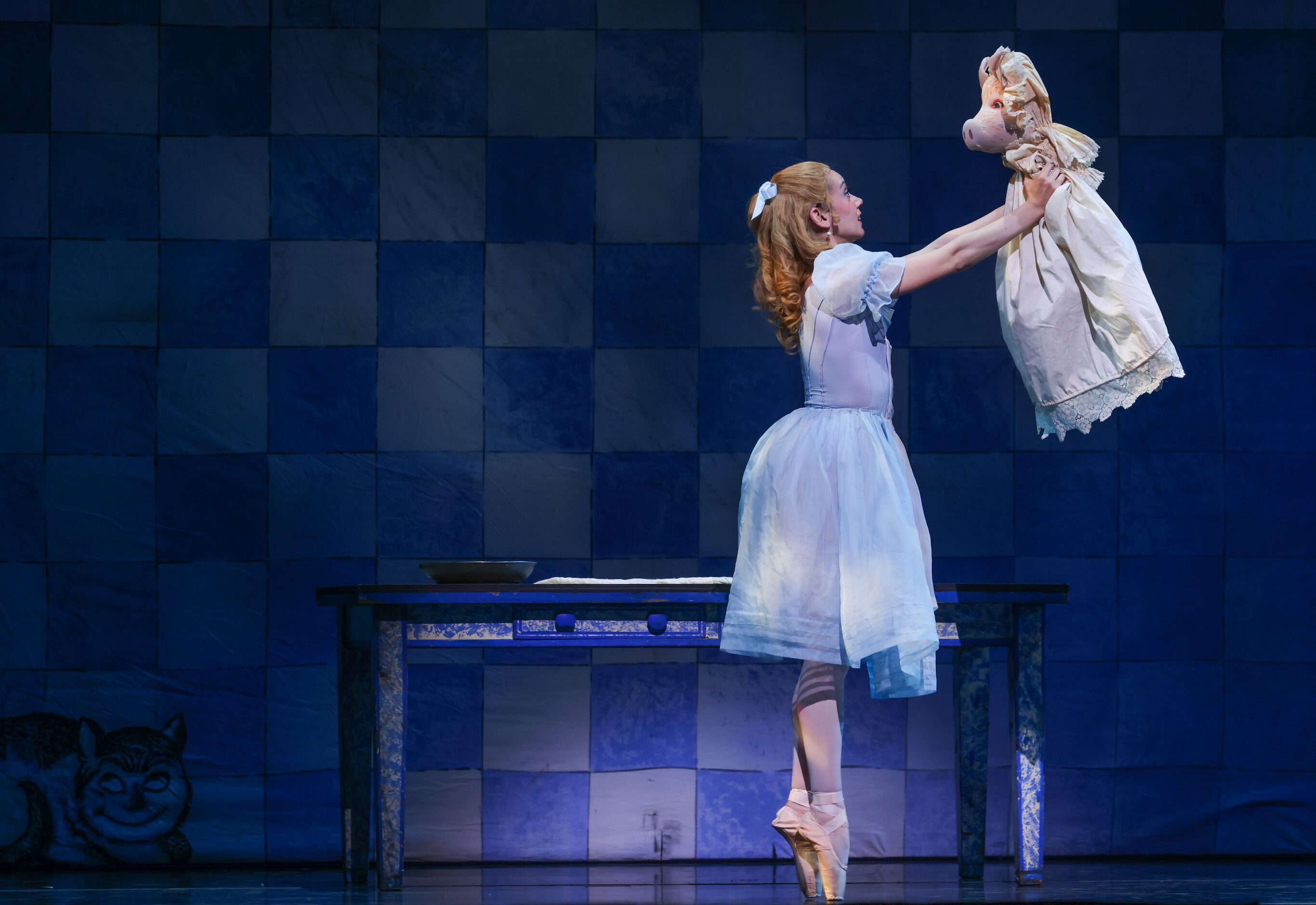 Alice (Alexandra F. Light) quiets the Pig Baby with soft motions during a dress rehearsal of...