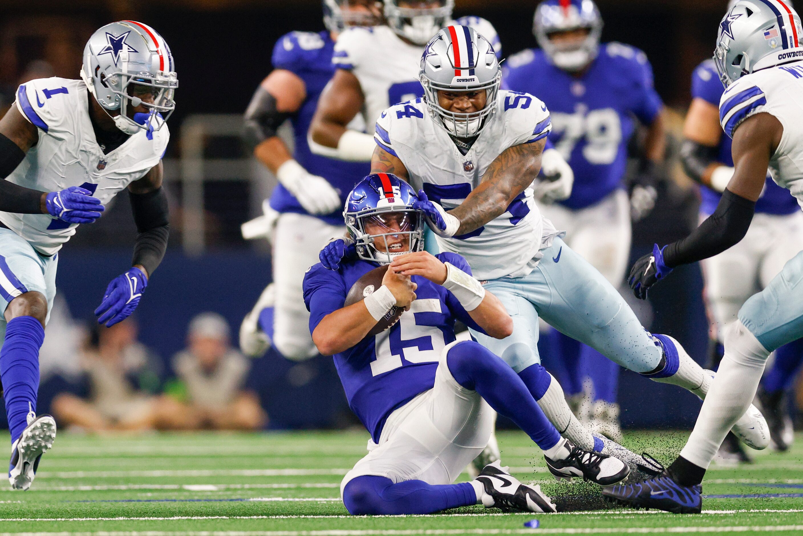 Dallas Cowboys quarterback Trey Lance (15) slides for a first down as Dallas Cowboys...