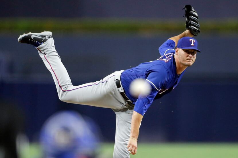 Texas Rangers pitcher Connor Sadzeck works against a San Diego Padres batter during the...
