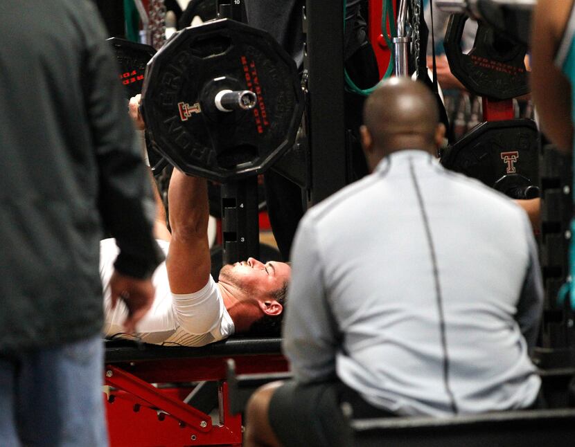 Tyler Scalzi does the bench press during Texas Tech's pro day at Jones AT&T Stadium Friday,...
