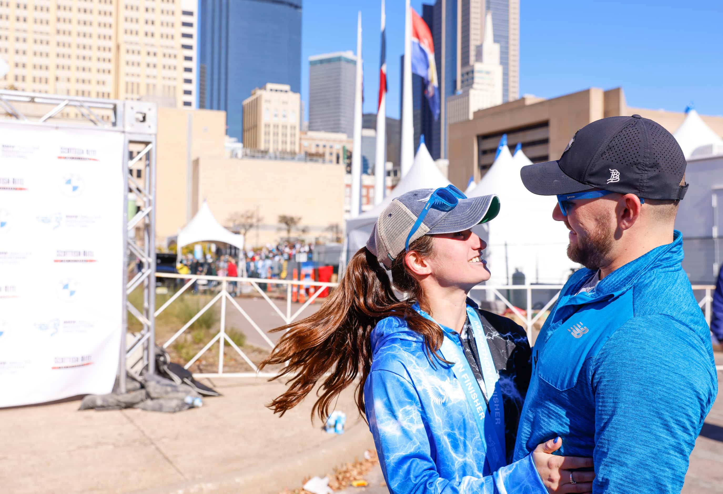 Women’s marathon finisher Jill Wolf of Dallas cheers with her husband Paul during 2023 BMW...