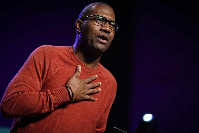 A man in a red sweater worshipping at Concord Church in Dallas.