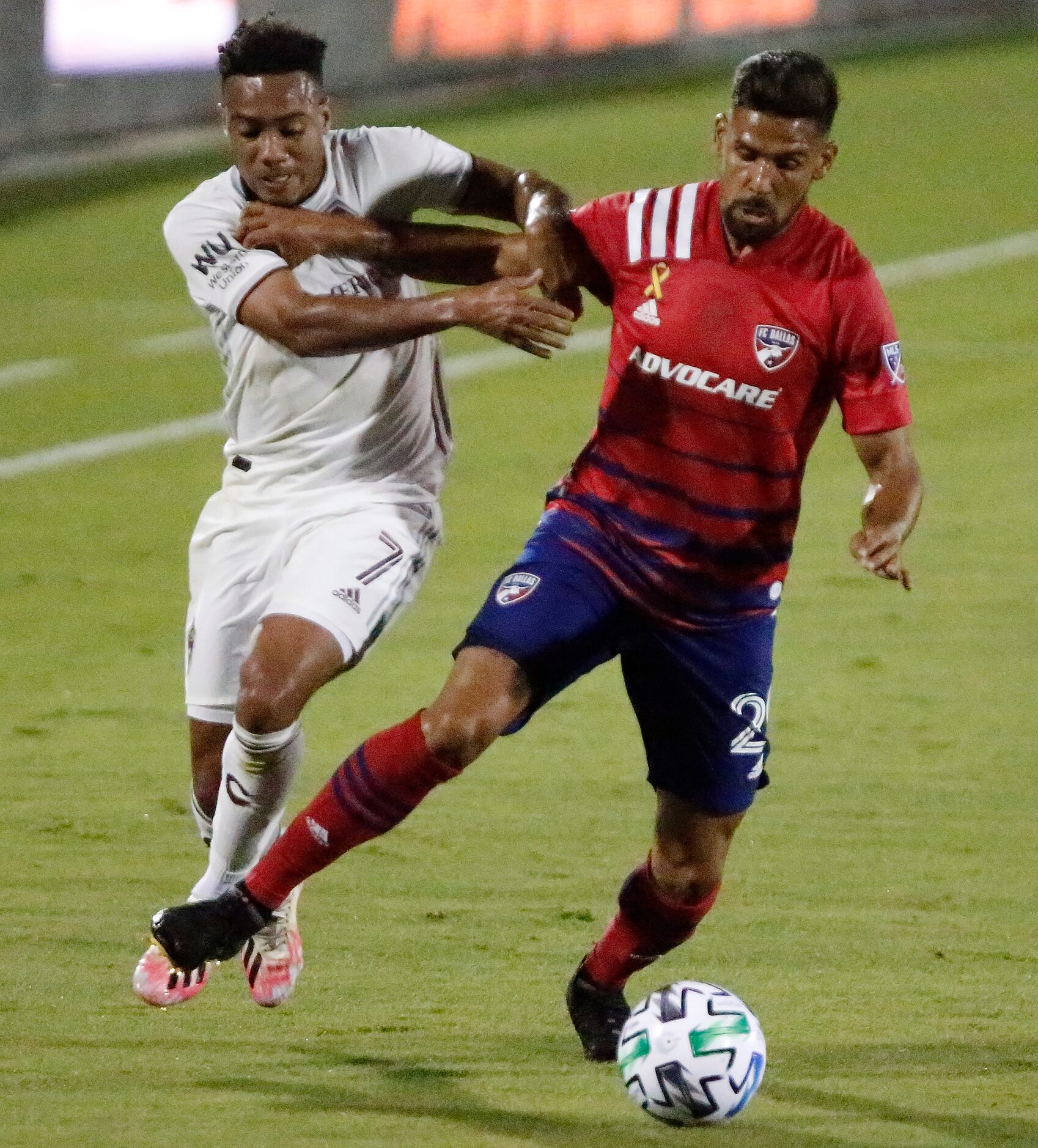 FC Dallas forward Franco Jara (29) shields the soccer ball from Colorado Rapids forward...