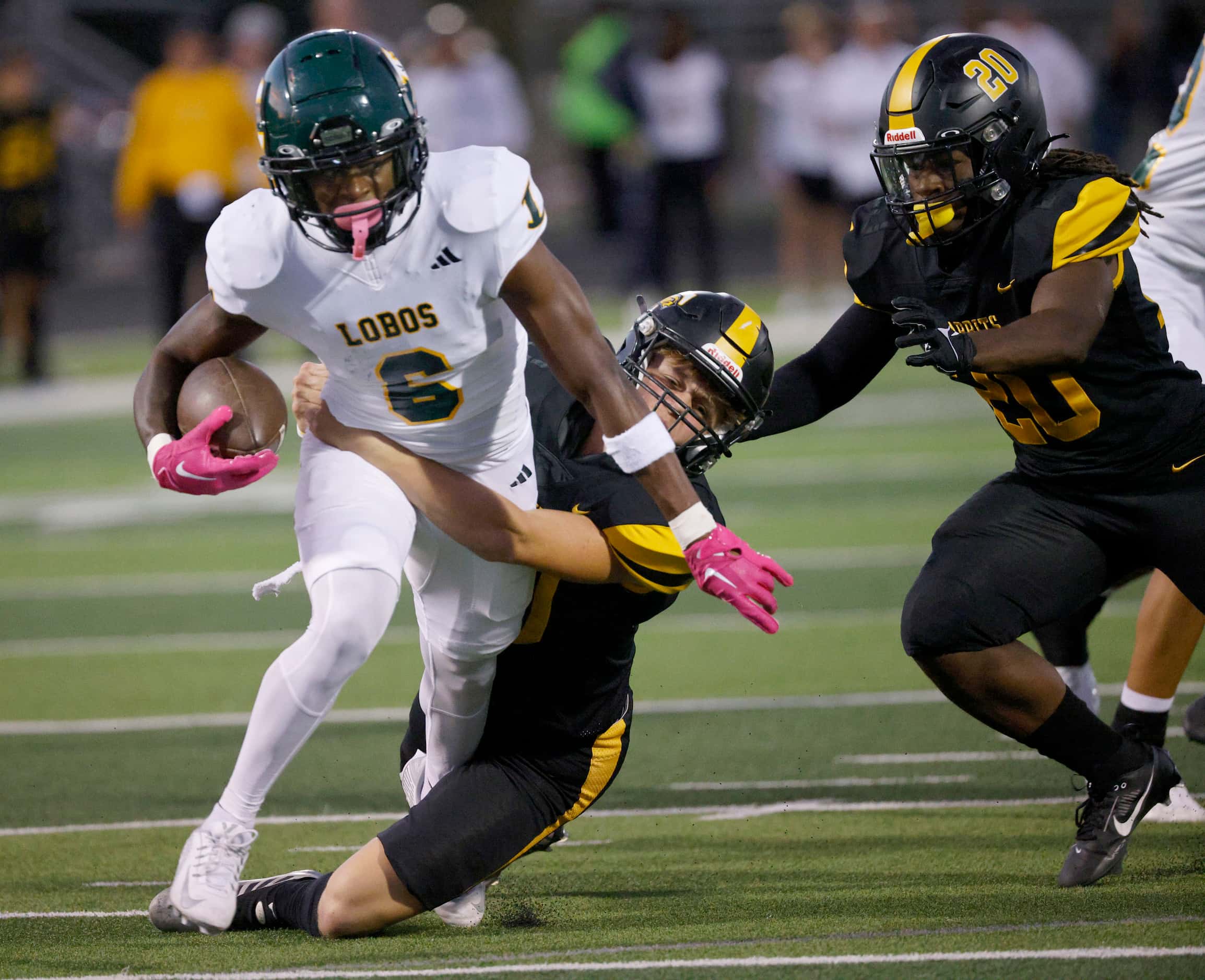 Longview's Willie Nelson (6) is tackled by Forney's Bryce Lott (30) as Forney's Xzavier...