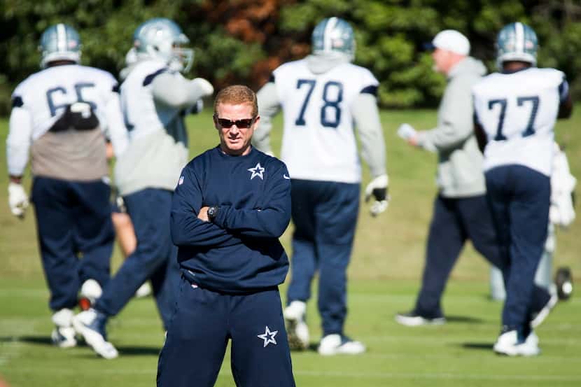 Dallas Cowboys head coach Jason Garrett watches his team during practice at the team's...