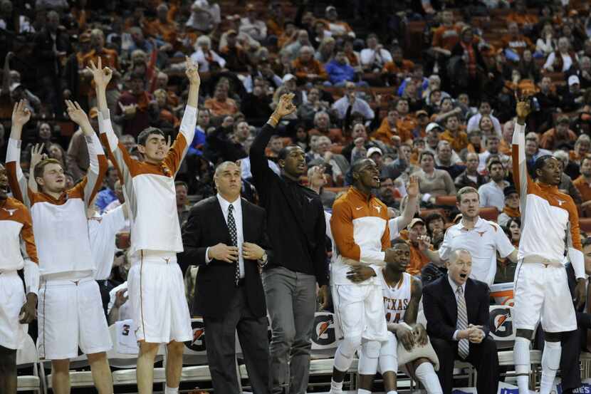 Feb 11, 2014; Austin, TX, USA; Longhorn players celebrate from the bench against the...