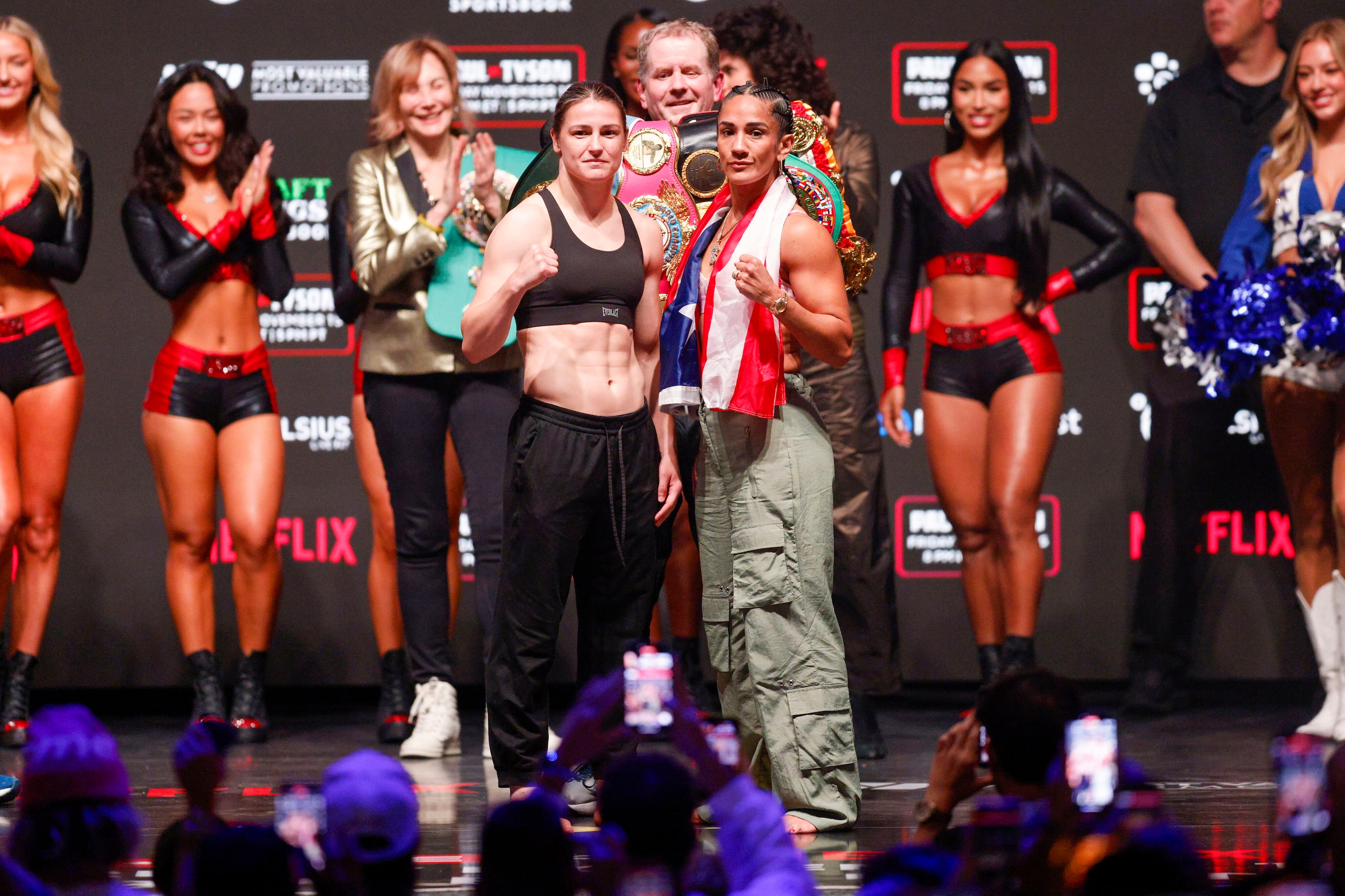 Katie Taylor (left) and Amanda Serrano pose for photos during public weigh-ins ahead of...