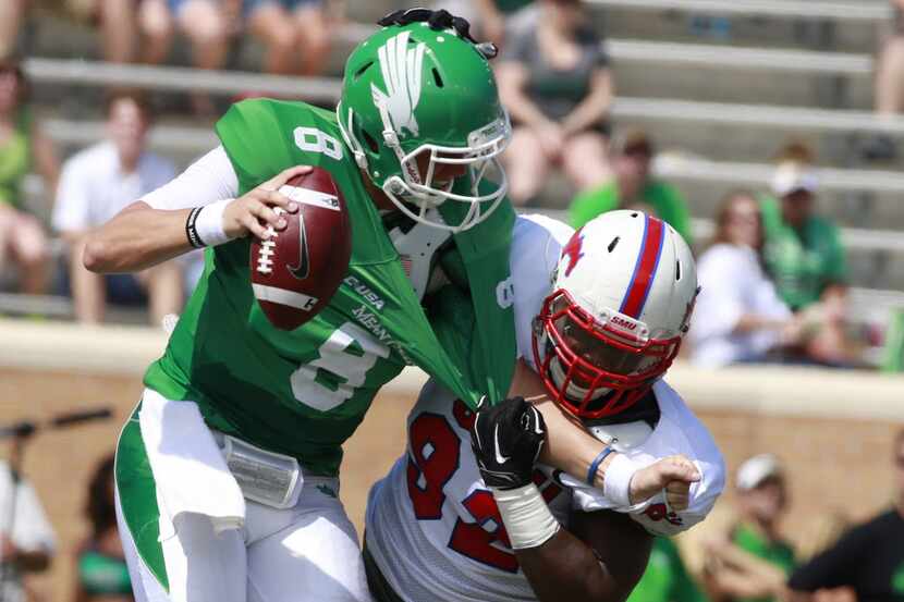 Sep 6, 2014; Denton, TX, USA; North Texas Mean Green quarterback Josh Greer (8) is sacked by...