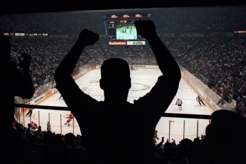 10/5/1993.. A Dallas Stars hockey fan cheers on his team, which is playing against Detroit...