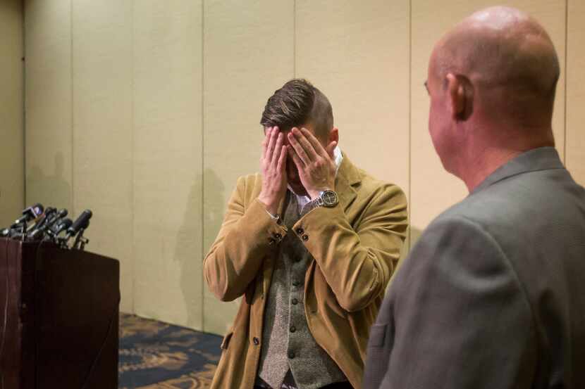 Richard Spencer rubs his eyes as he talks with organizer Preston Wiginton after a press...