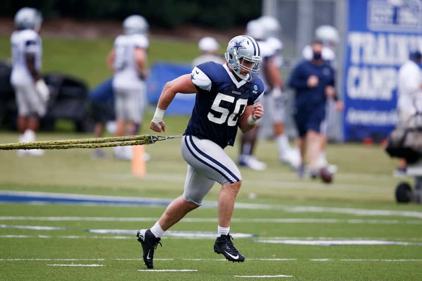 Cowboys linebacker Sean Lee (50) works with team trainer Britt Brown during training camp at...