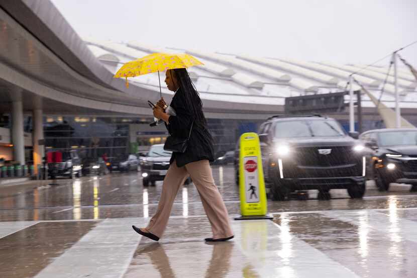 Alexis Alexander crossed the street in the rain to go to work at the Grand Hyatt on Friday,...