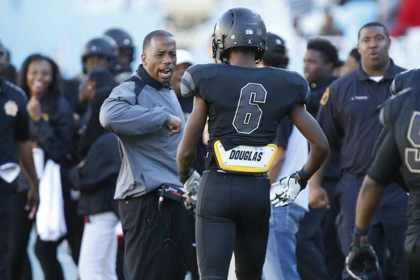 South Oak Cliff head coach Emmett Jones congratulates wide receiver J.F. Thomas (6) after he...