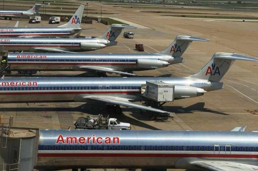  American Airlines jets line up at Dallas/Fort Worth International Airport gates in this...