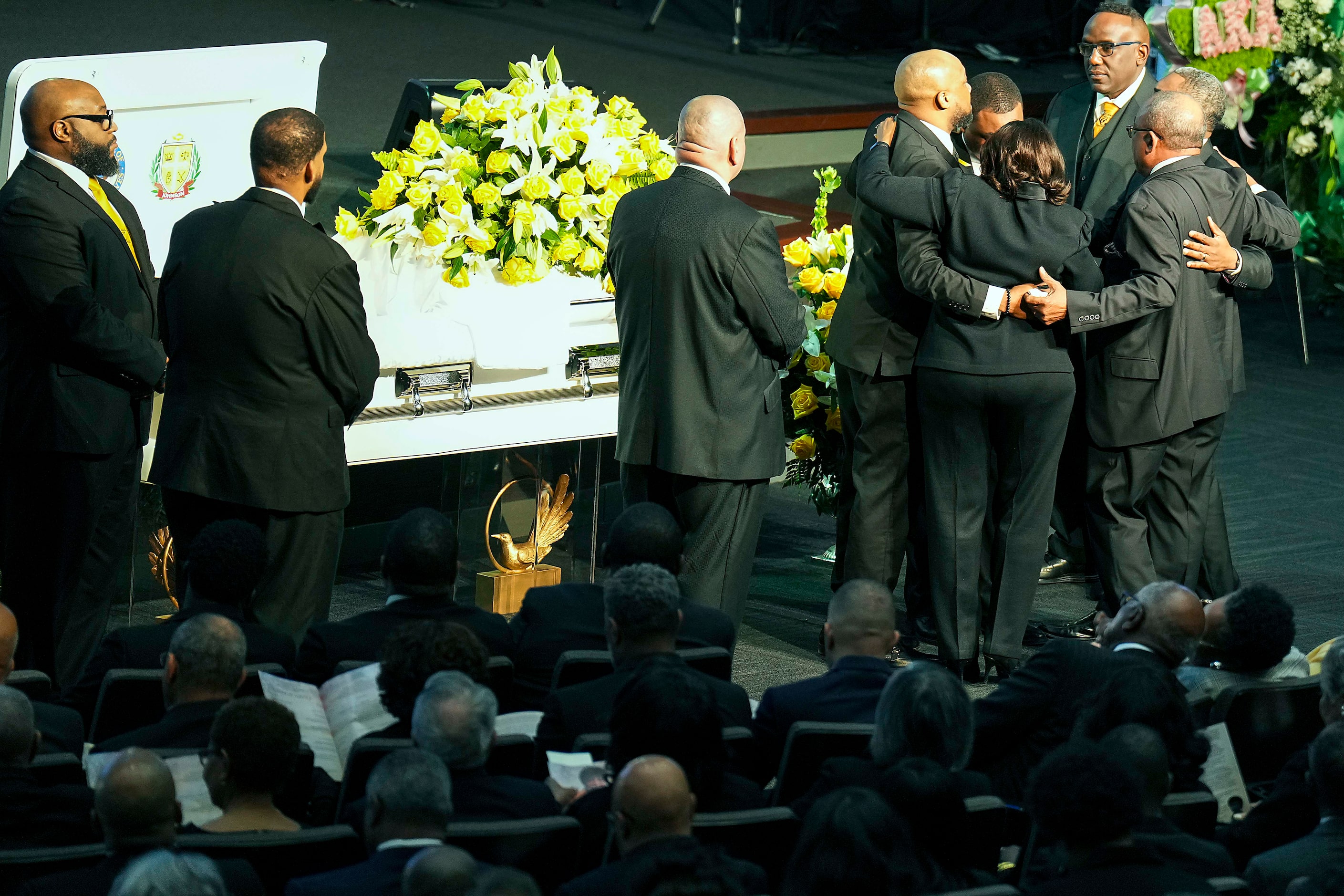 Family members embrace near the casket during funeral services for former U.S. Rep. Eddie...