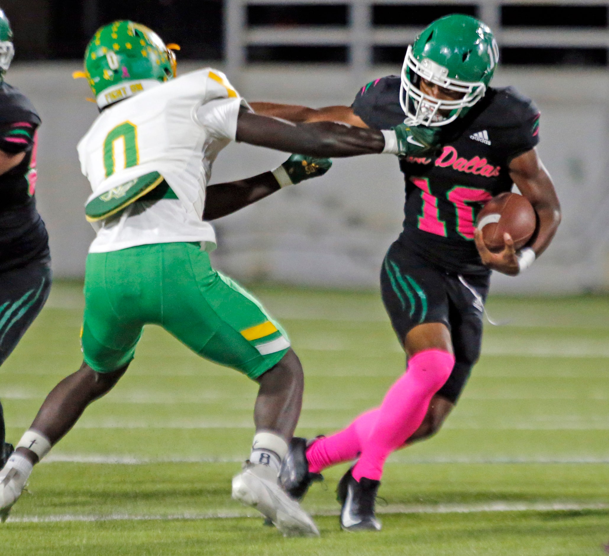 Carrollton Newman Smith High defender Ja’Coreyon Swinney (0) tackles Bryan Adams High Tyriq...