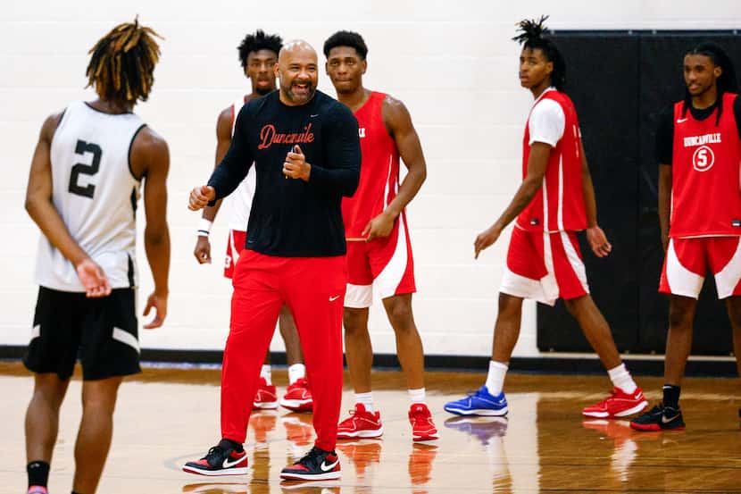 Duncanville boys head basketball coach David Peavy laughs with the team during a practice,...