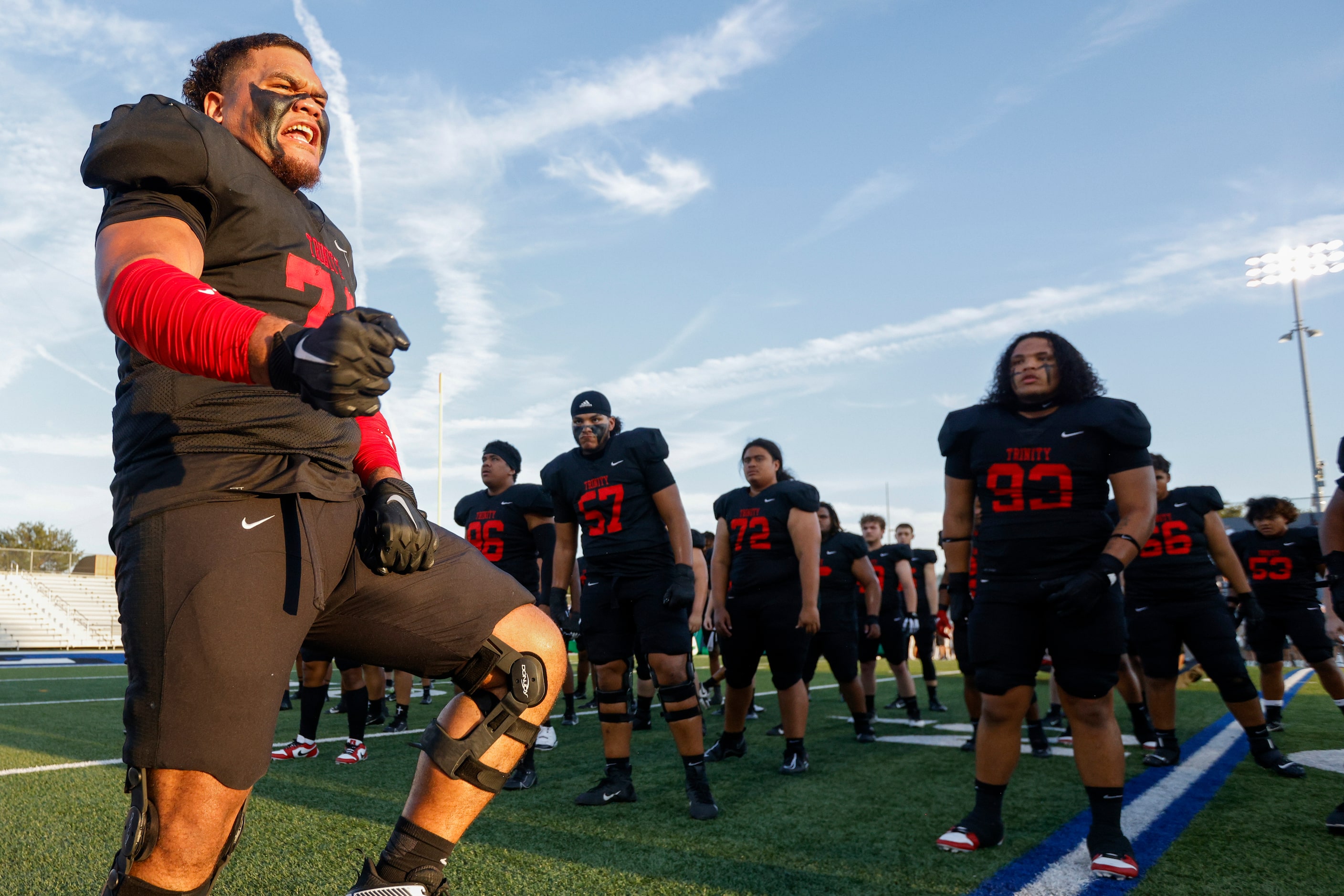 Euless Trinity offensive lineman Philip Tuipulotu (left) leads the team in the Sipi Tau...