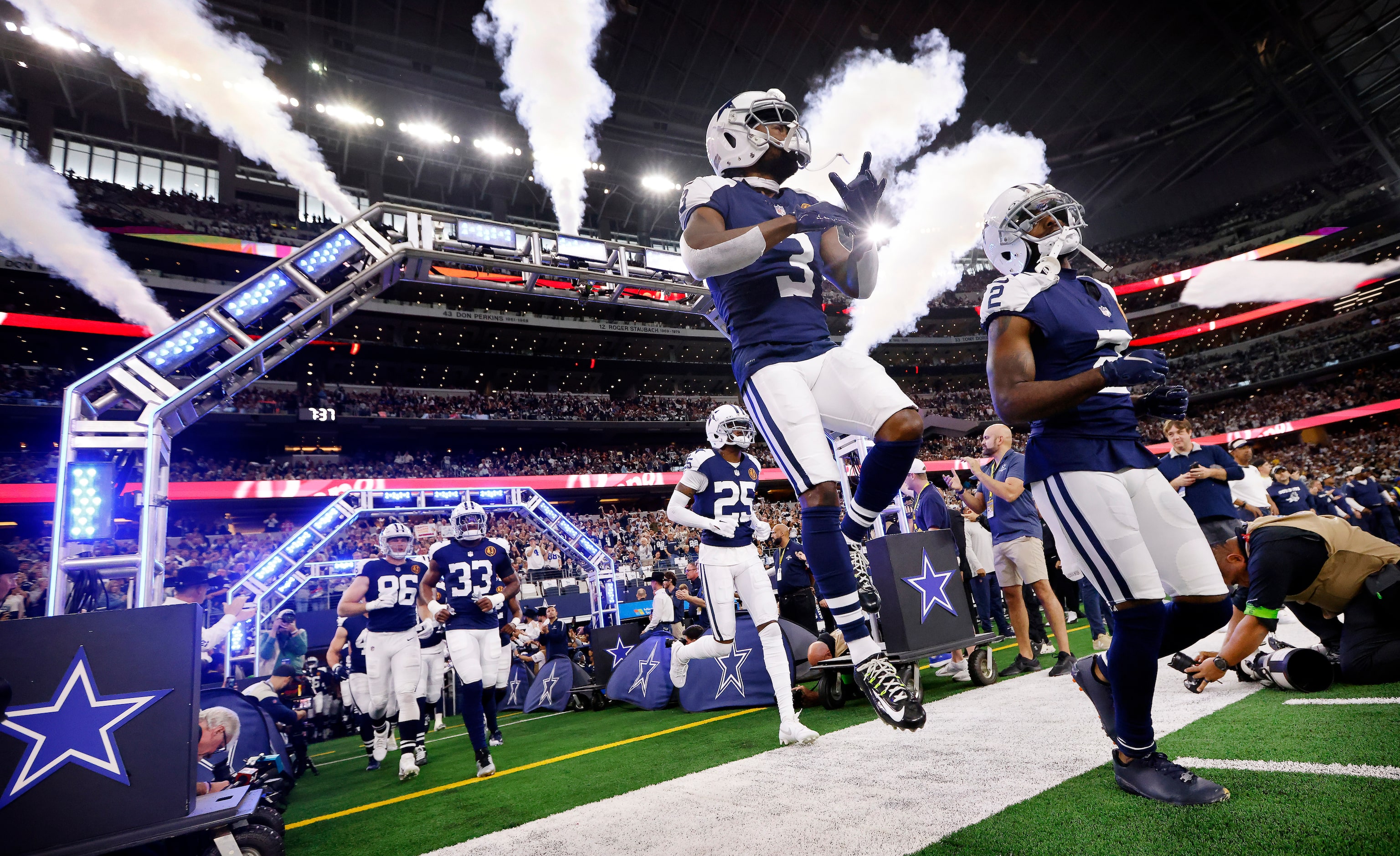 Dallas Cowboys wide receiver Brandin Cooks (3) leaps across the sideline as he and Jourdan...